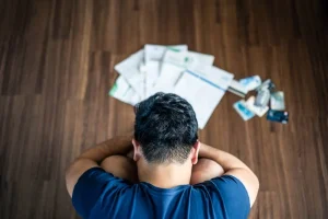 man struggling with debts