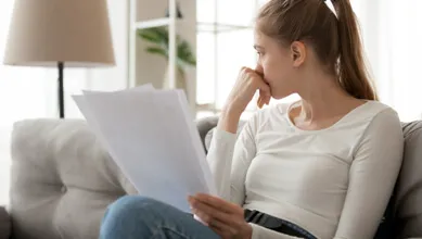 Worried woman looking at bills