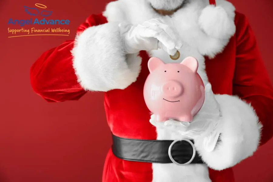 Father Christmas holding a piggy bank