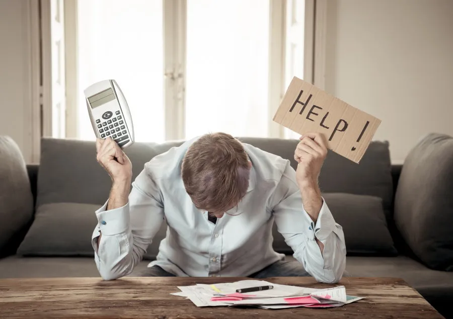 Man holding help sign and calculator