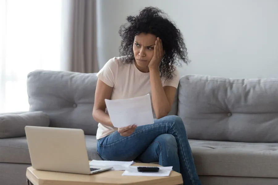 Woman looking concerned at a bill