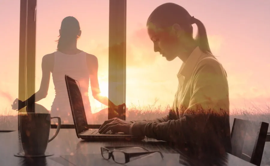 Woman working on a laptop and practising yoga