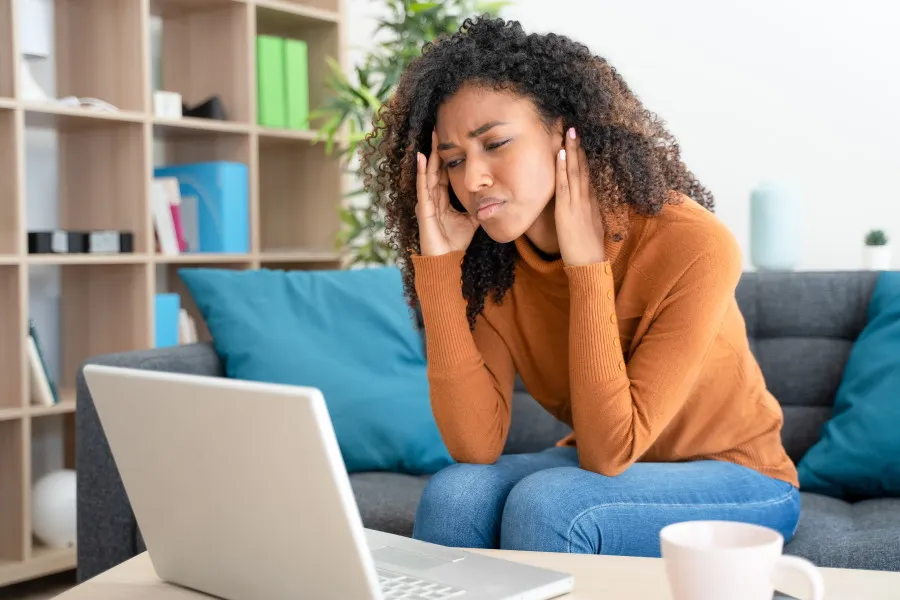 Woman looking stressed at computer