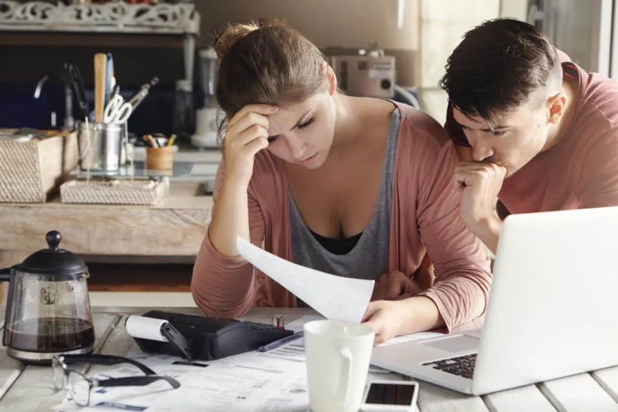 Worried couple looking at documents