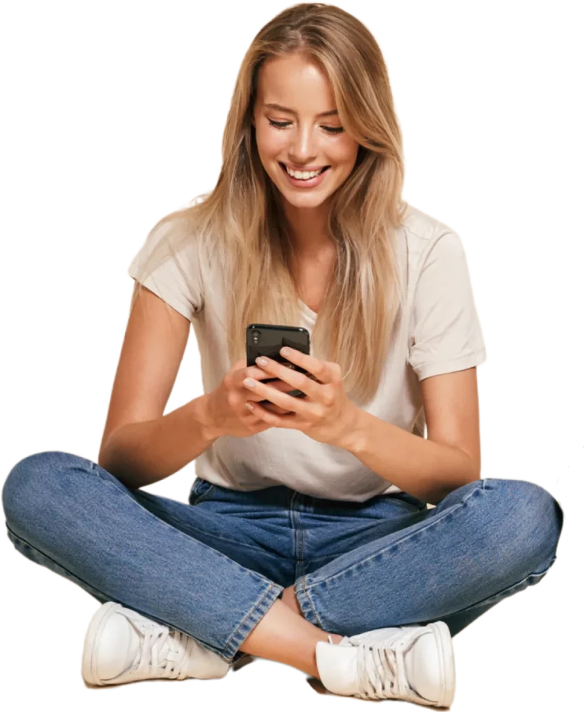 Blonde woman sat cross-legged on the floor on her phone