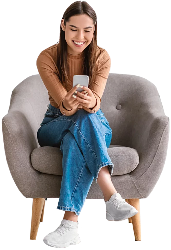 Brunette woman sat down smiling at her phone