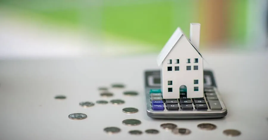 Paper house sat on top of a calculator