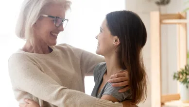 Older woman hugging a young girl