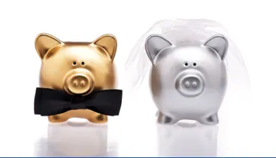 2 piggy banks dressed as a bride and groom