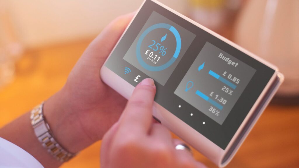image of a hand holding a smart meter for energy bill