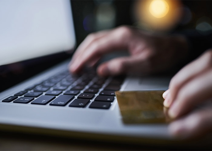 a credit/debit card on the edge of a laptop