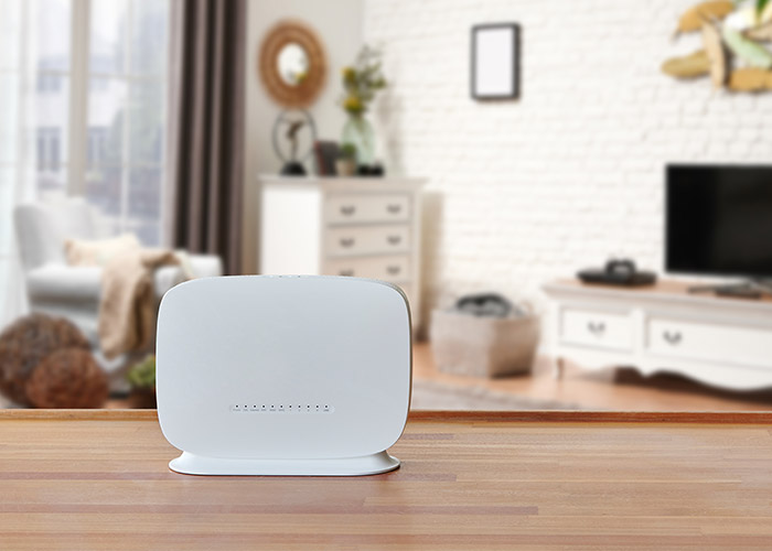 Modem and router box on the table and living room background blur concept.